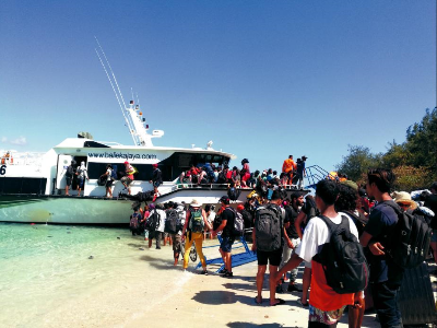 8月6日，游客在印度尼西亚龙目岛附近的特拉旺安岛海滩上等待登船撤离。新华社 发